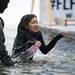 A Ford Lake Frozen Leap participant makes her way out of the cold water on Saturday, Feb. 16. Daniel Brenner I AnnArbor.com